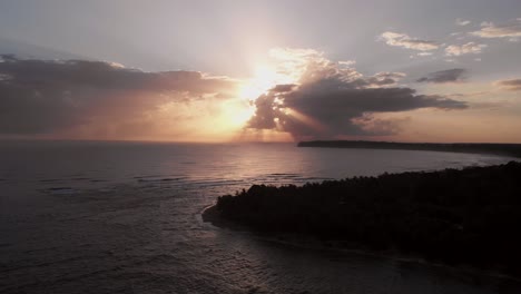 the beautiful colors of sunset over the costa rica shoreline and waves - aerial