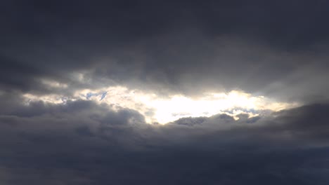time lapse of dark clouds with sun light pushing through them