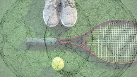 white athletic shoes lying near top edge, tennis racket spanning center, tennis ball resting bottom