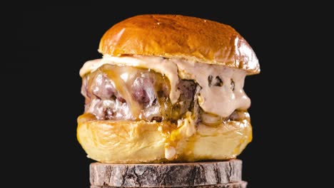 delicious burger rotating on wooden stand. stop motion