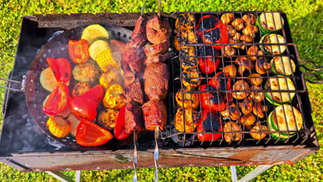 delicious and colorful variety of food, including meat skewers, peppers, corn, and mushrooms, grilling at a summer barbecue - a top-down push-in