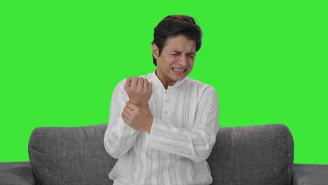 sick indian man having hand pain green screen