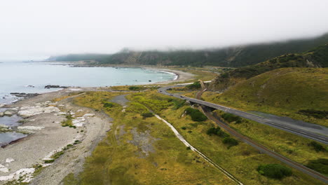 aerial shot over the coast of kaikoura, new zealand in a misty, and cloudy day