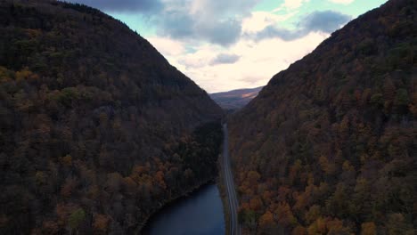 beautiful drone footage of a deep autumnal valley with beautiful colors and mountain road