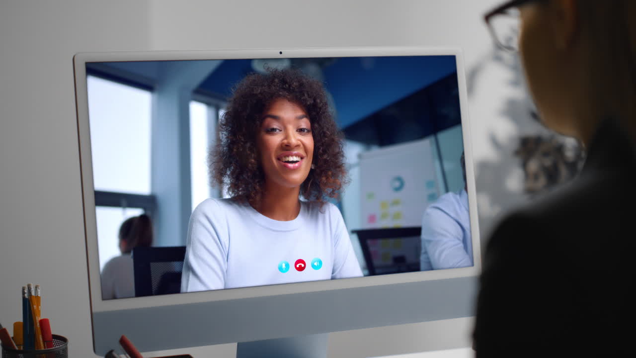 Woman talking web chat at office computer close up. Girl making video call