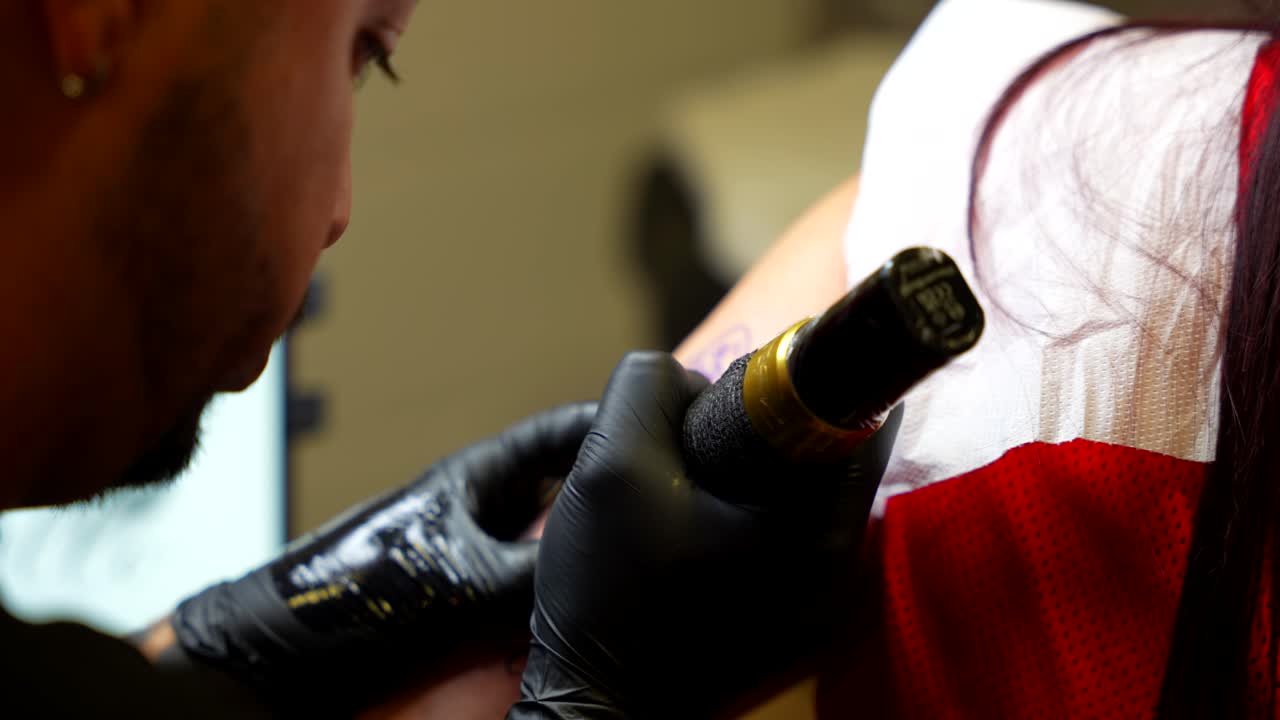 Tattoo Artist Applying Ink to Client's Arm