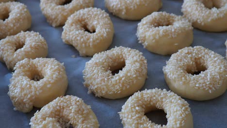 close-up sesame seeds stuck to the dough, tiny bagels with sesame seeds,