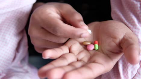 person holding various pills in their hand