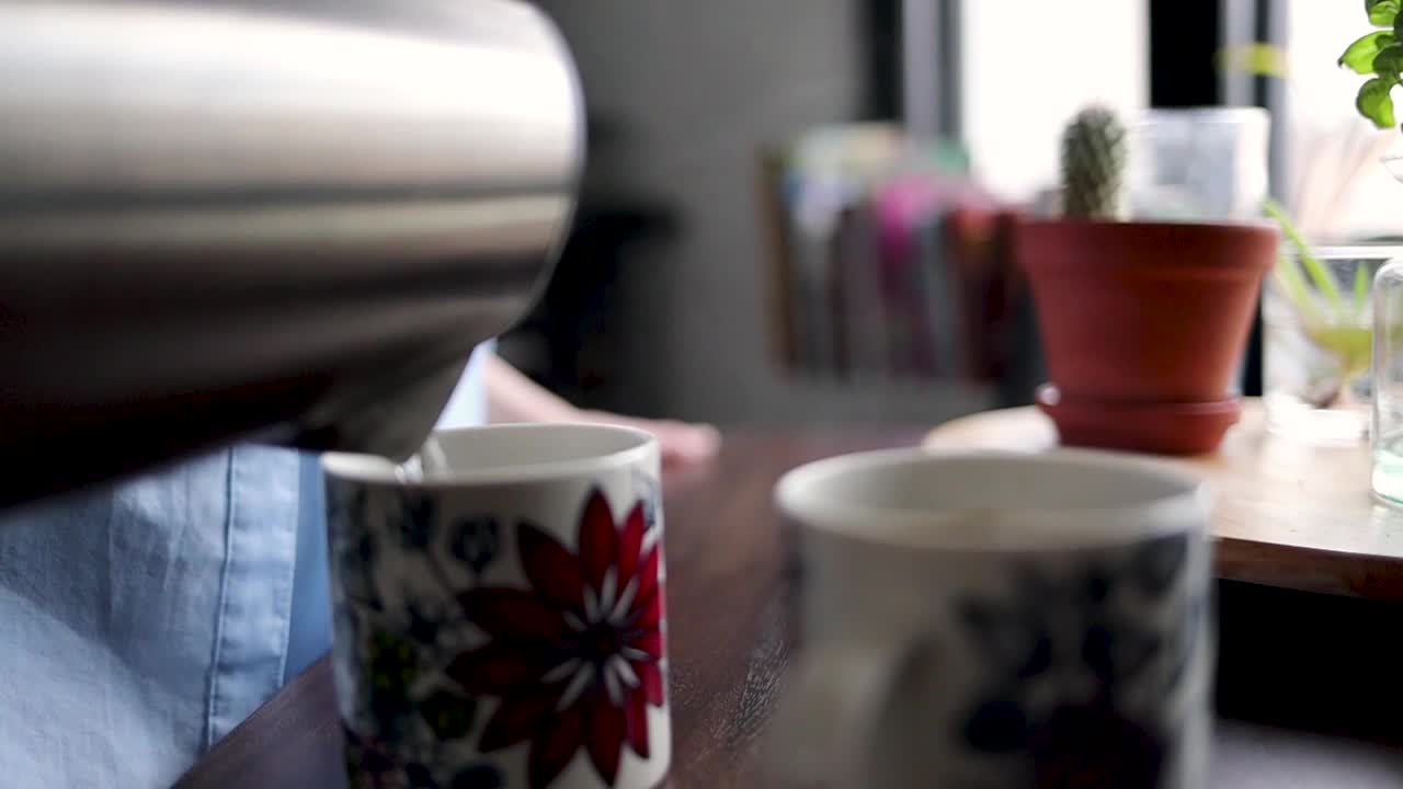 Sirviendo una bebida caliente en tazas