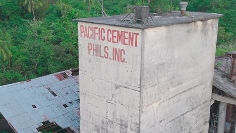 abandoned and dilapidated cement factory in surigao del norte - philippines, surrounded by jungle