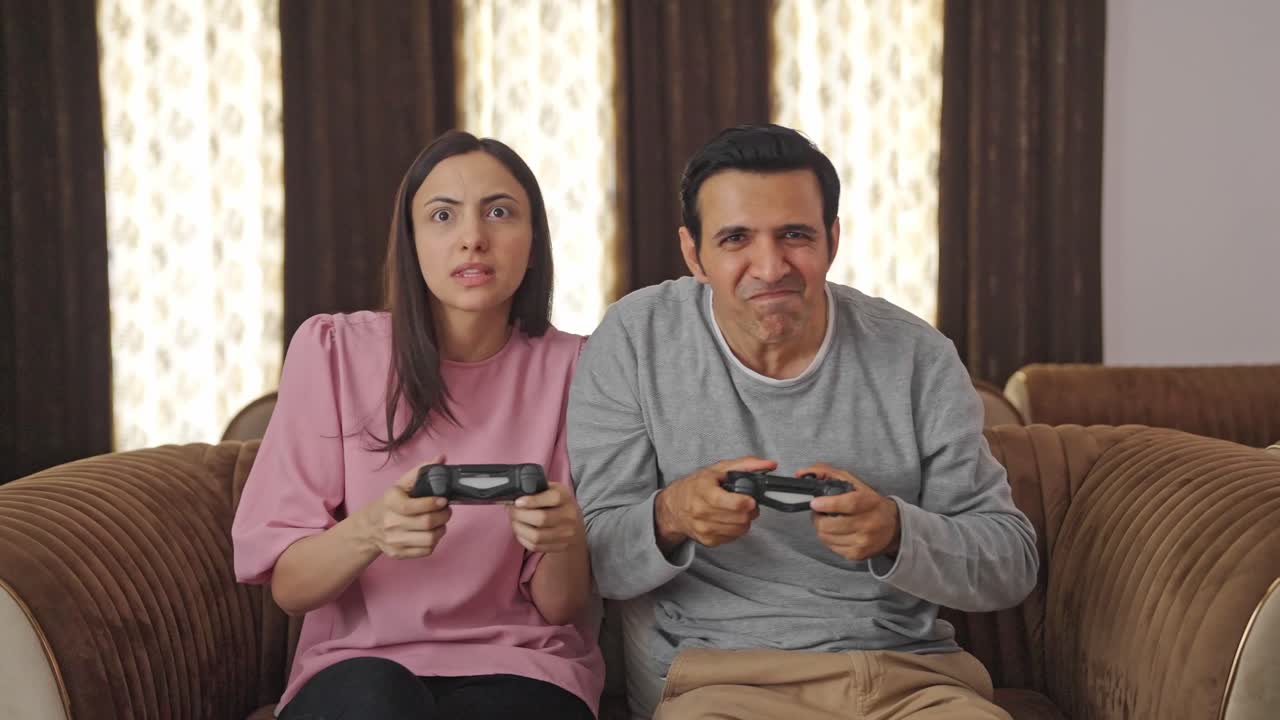 비디오 게임을 하는 경쟁력 있는 인도 커플