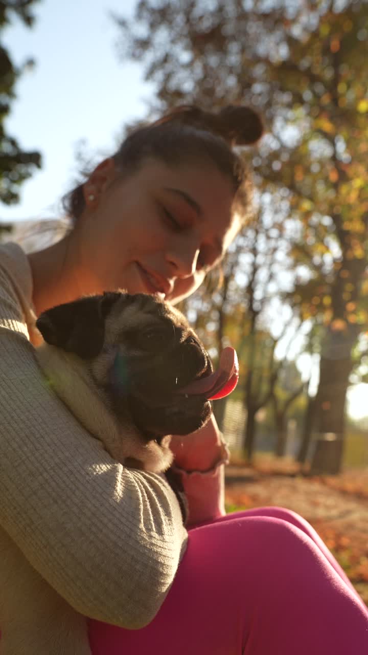 공원에서 파그를 안고 있는 소녀