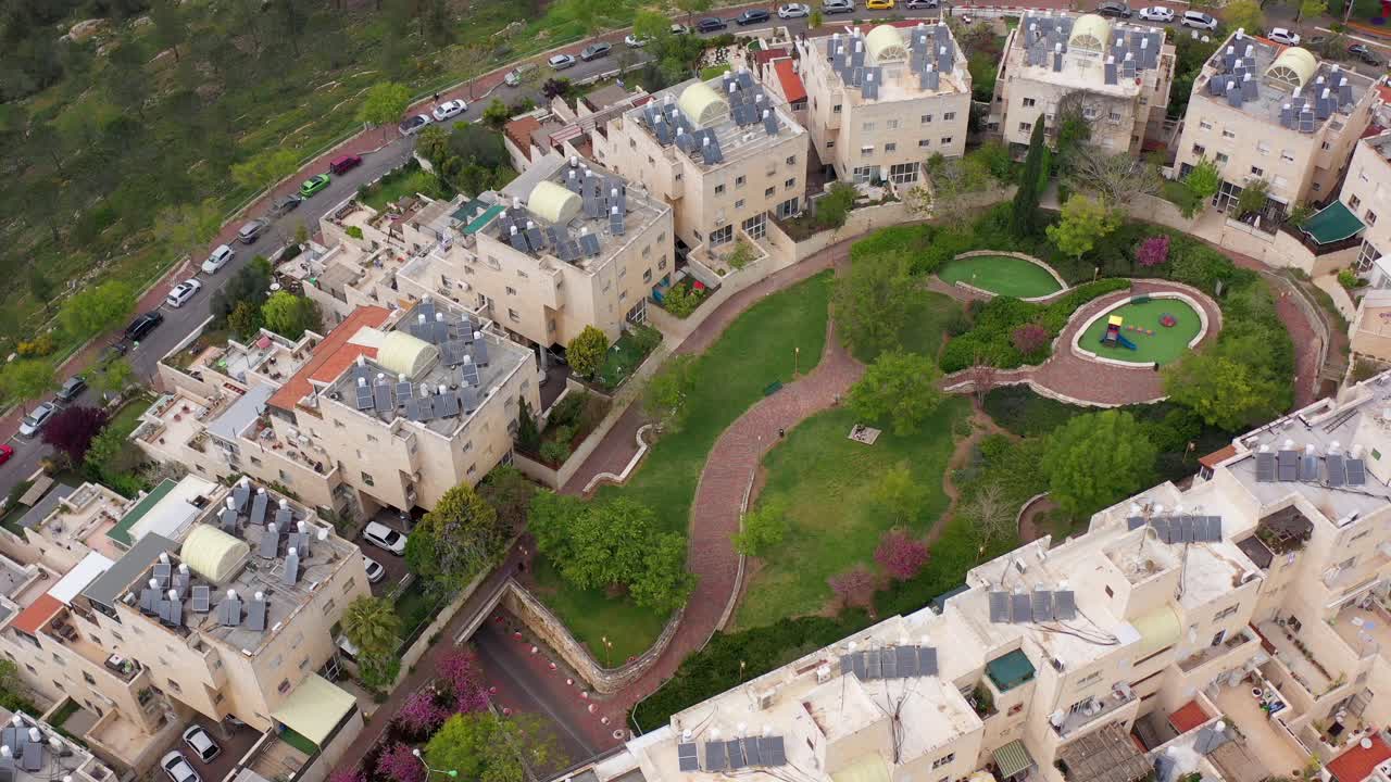 Aerial Drone View of a Modern Residential Neighborhood with Green Parks and Solar Panels
