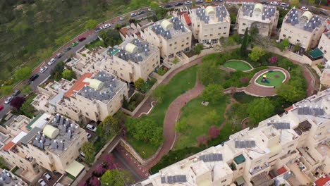 aerial drone view of a modern residential neighborhood with green parks and solar panels