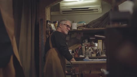 tracking shot in slow motion of craftsman while working in his workshop