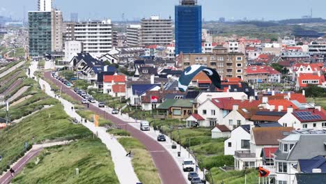 close up orbiting shot revealing a busy beach along the coast in the city of zandvoort in the netherlands