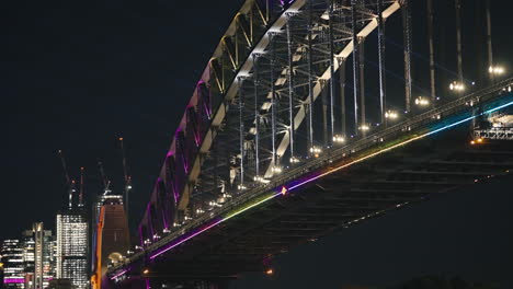 multi colored neon lights shining on the sydney harbour bridge in slow motion