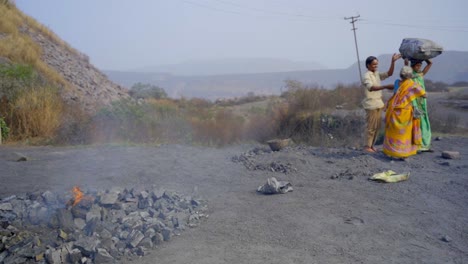 manual laborers working with coal in rural india