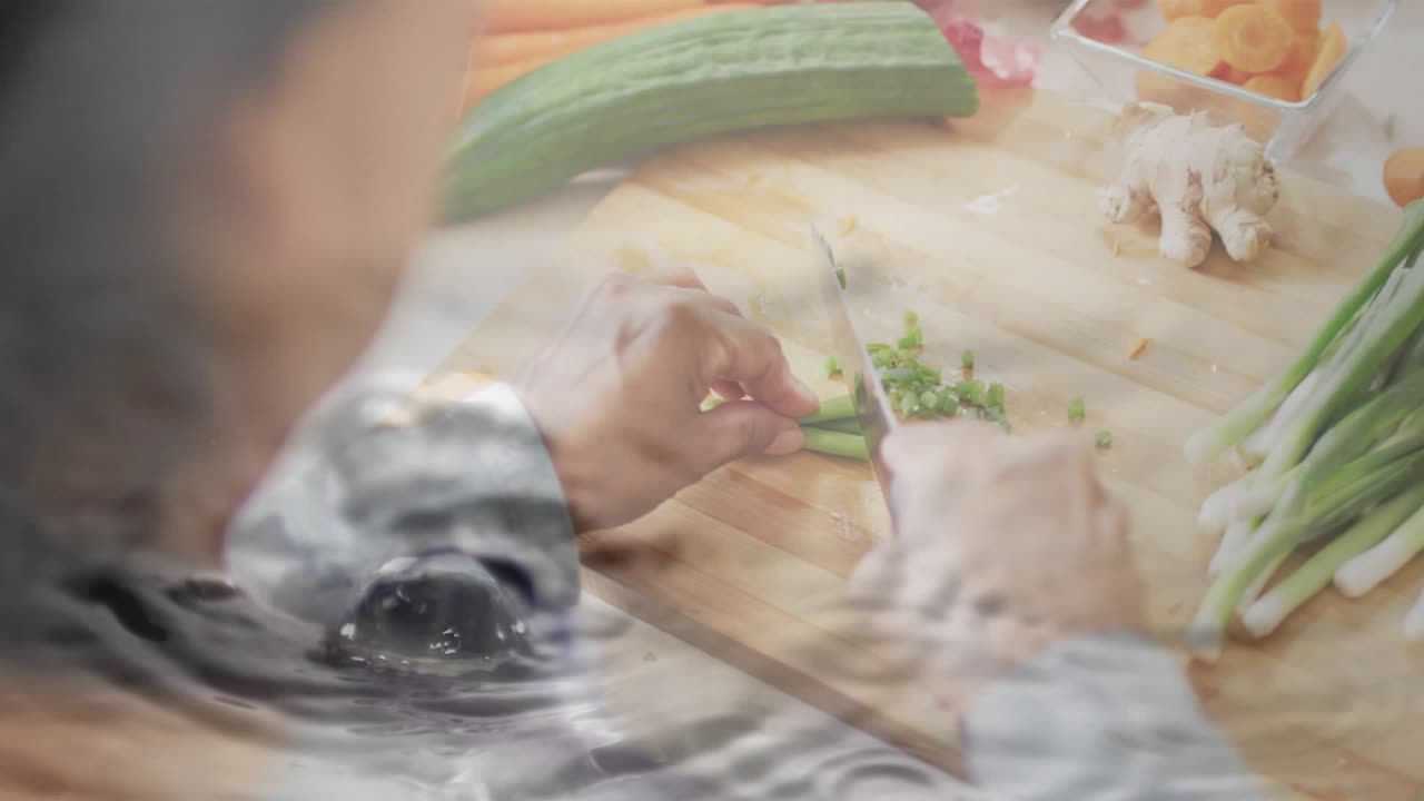 Home cook placing scallions and initiating knife slicing while droplets sliding, rippling meal prep