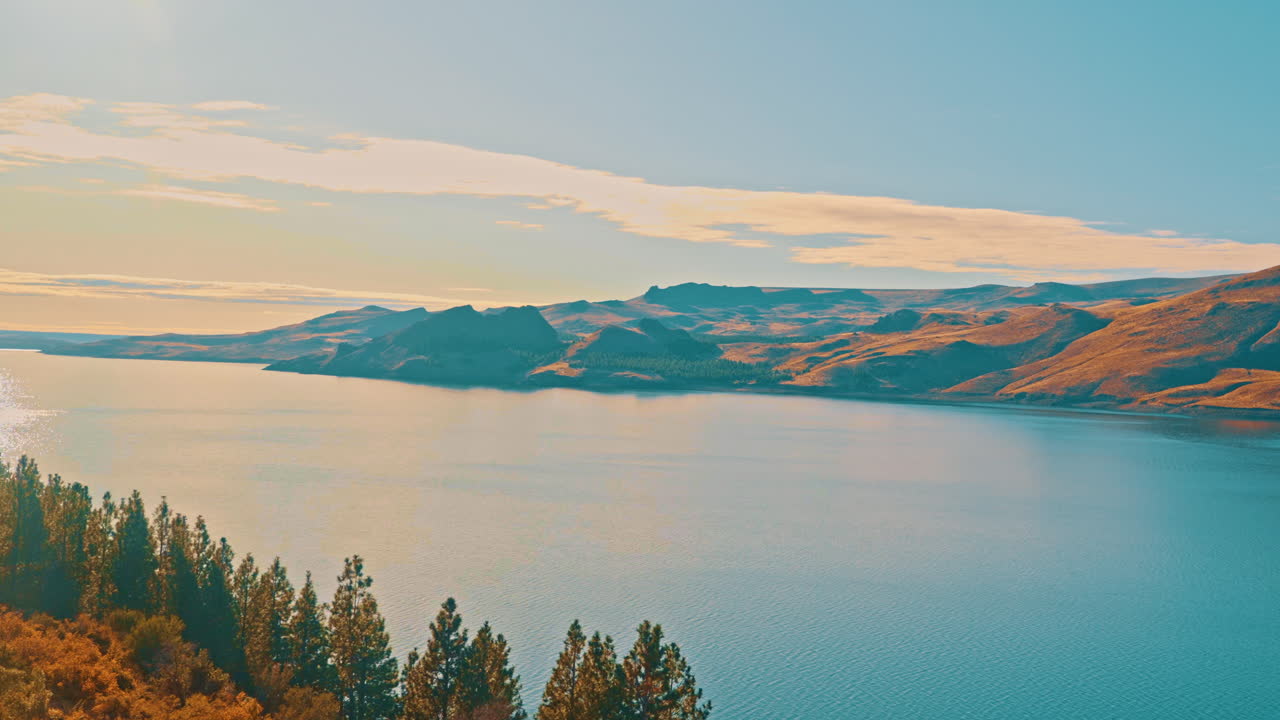Scenic Landscape of a Vast Lake Surrounded by Golden Hills