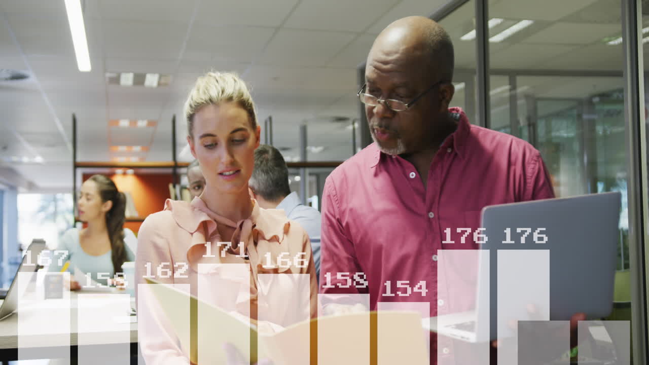 Animation of statistical data processing against diverse man and woman discussing at office