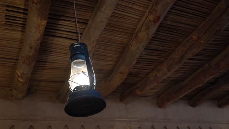 closeup view of hanging lantern lamp on wooden roof, arab culture