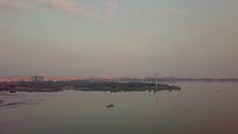 wide angle view of sunset over lake in hyderabad, india. drone view.