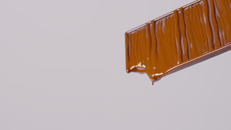 close up of melting chocolate bar against white background with copy space 2