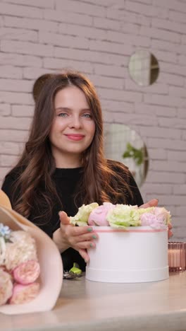 a talented woman arranges colorful flowers in a stylish box showcasing her artistic creativity and