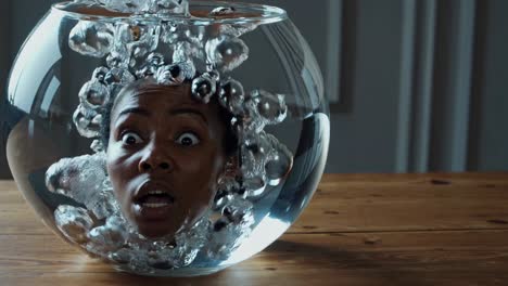 woman's head in a fishbowl with bubbles