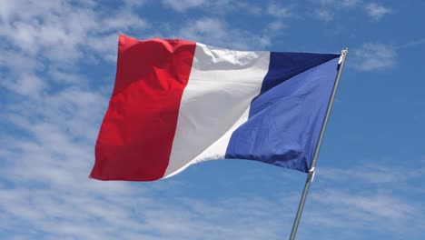 france flag waving in the wind in slow motion close up with sky background