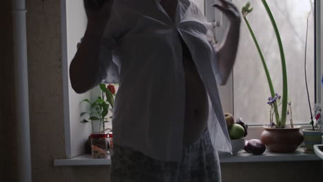 pregnant woman dancing at home