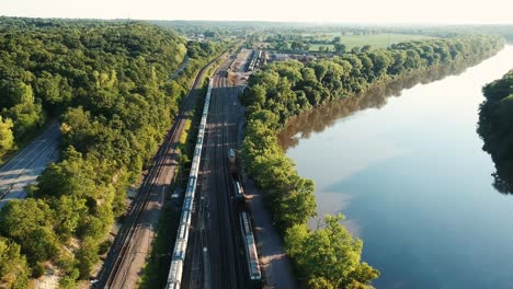 Drone video lowering down towards train tracks with river next to it