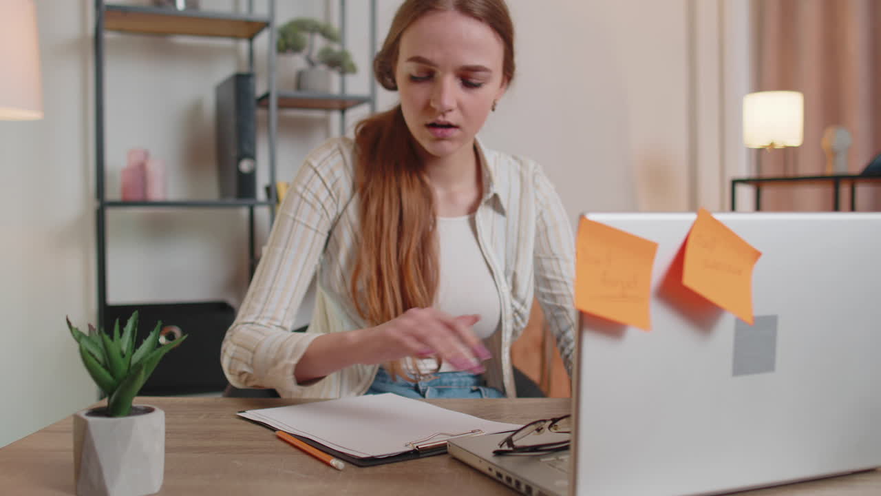 Nervous adult freelancer girl confused by big routine laptop work loading indoors at home office