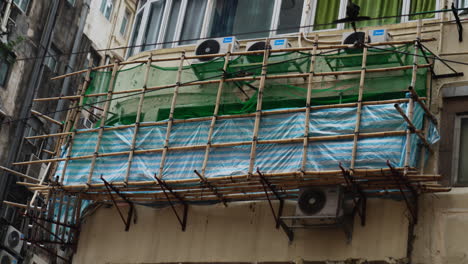 close-up shot of a construction site on the side of a building with air conditioning in hong kong