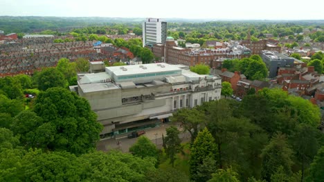 overhead reversing aerial video of ulster museum in botanic gardens in belfast, northern ireland on a bright sunny day. produced in 4k, 60 frames per second and with rec709 color.