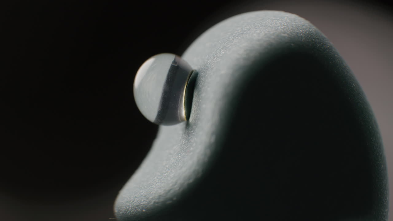 Close-up of a Water Drop on a Gray Foam Object