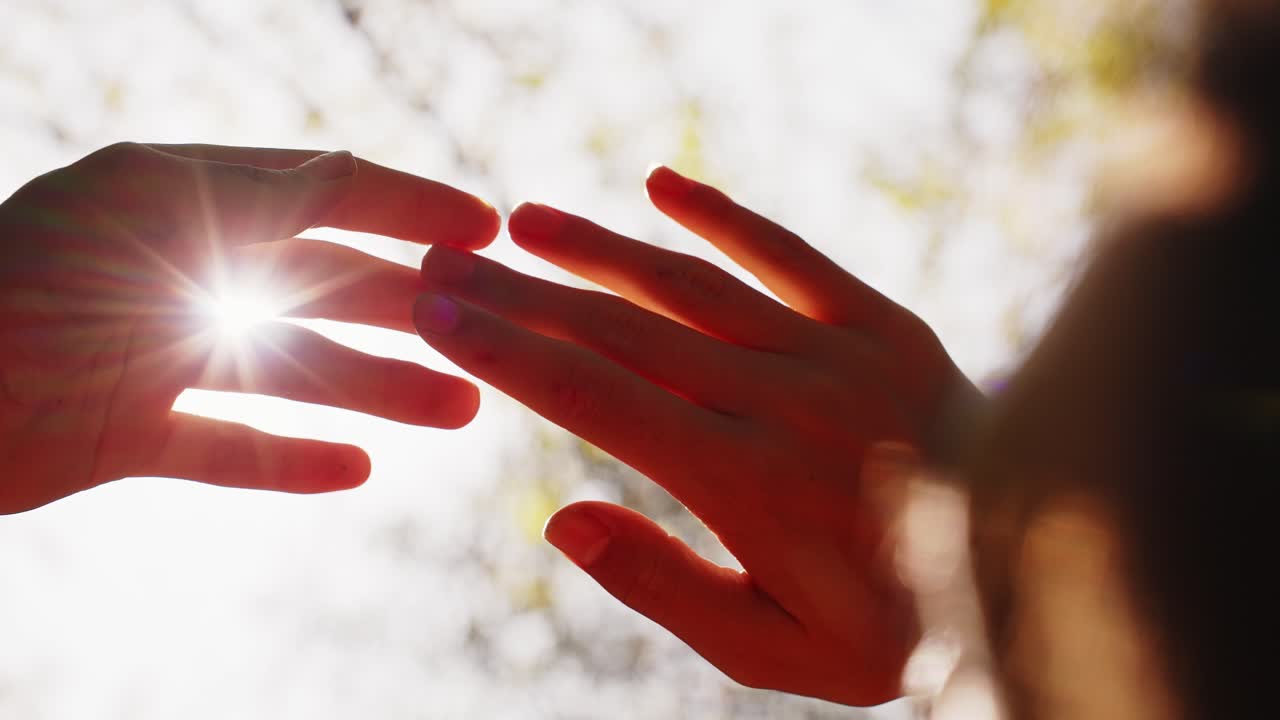 A Serene Moment of Connection: Hands Reaching Out Beneath a Glowing Sun, Celebrating Bonding and Shared Humanity in a Warm, Soft Light
