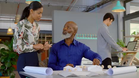 executives discussing over architectural model 4k