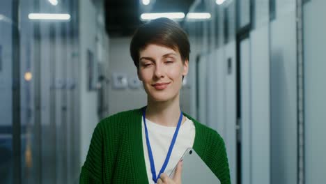 businesswoman in office corridor with tablet