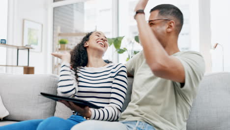 couple, tablet and high five on sofa in home