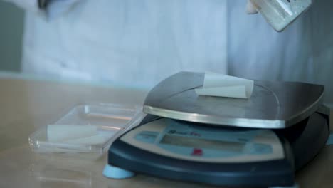 scientist weighing chemicals in a laboratory