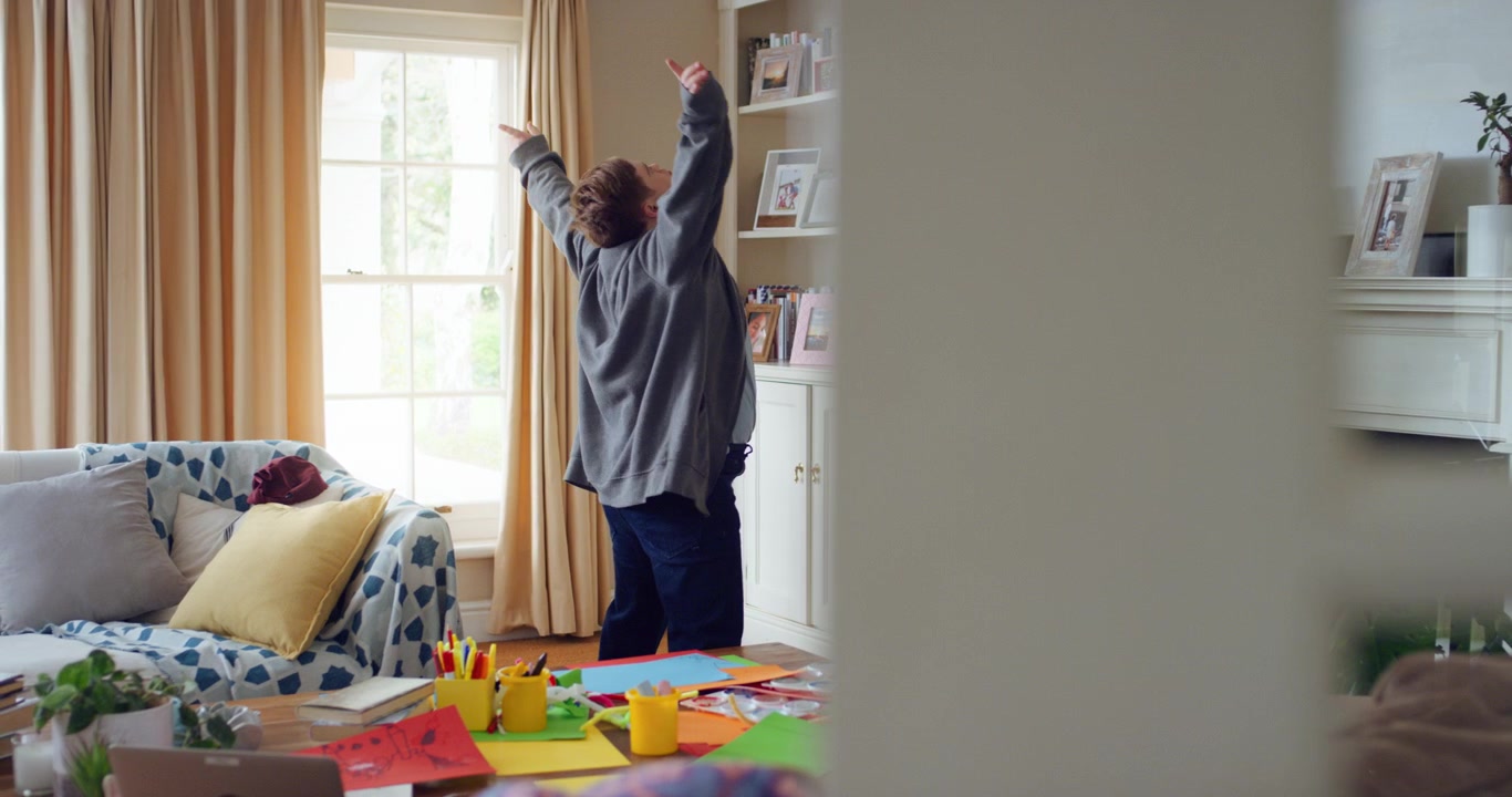 Young Man with Down Syndrome Dancing in Living Room