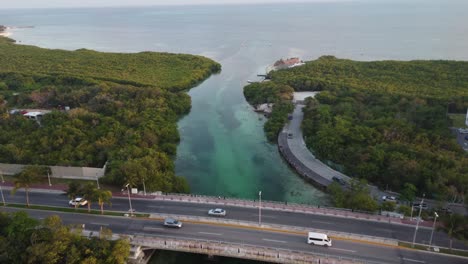 aerial shot overhead punta nizuc bridge showing the boating lane into the port