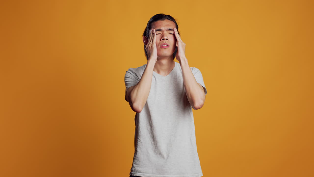 Sick male model dealing with painful headache,