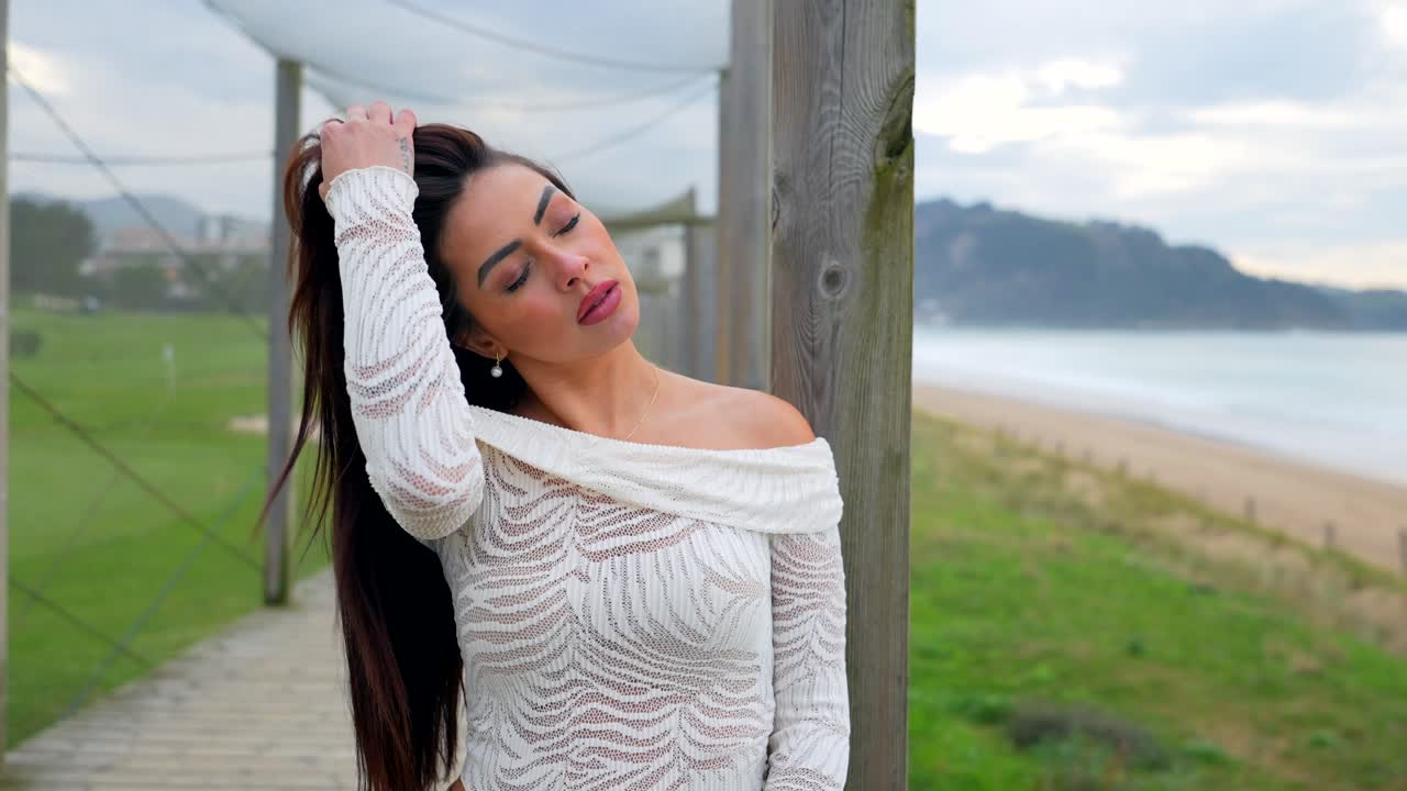 Woman on a boardwalk overlooking the ocean
