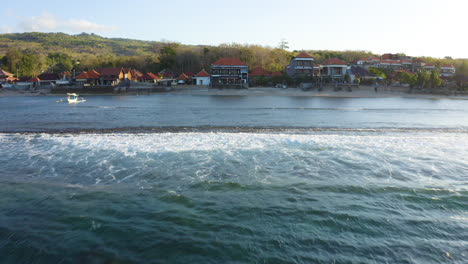 Drone-chasing-waves-in-Nusa-Penida-to-cinematic-filmed-amazing-traditional-Houses-and-Hindu-Temples