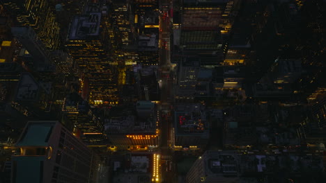 Vista-De-ángulo-Alto-De-La-Ciudad-De-Noche.-Incline-Hacia-Abajo-En-Los-Edificios-Y-Calles-Del-Centro-De-Gran-Altura-Iluminados.-Manhattan,-Ciudad-De-Nueva-York,-Estados-Unidos