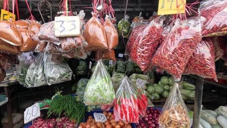 various vegetables being sold at a busy market