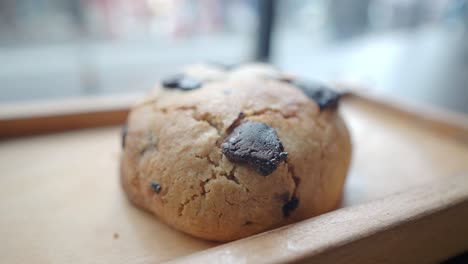 chocolate chip cookie on wooden tray